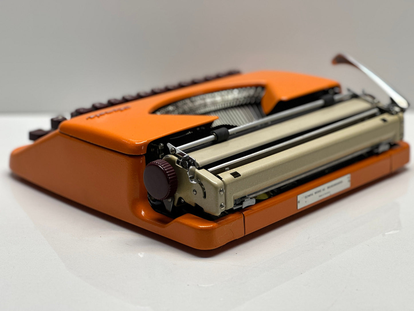 Olympia Splendid 33/66 Typewriter - QWERTY Keyboard, Burgundy Keys, Orange Typewriter, and Matching Bag