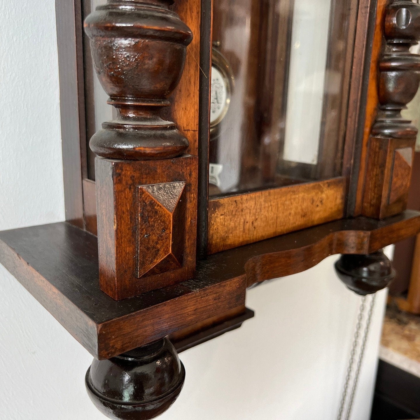 Close-up of antique solid wood wall clock, showing detailed craftsmanship and elegant design. Perfect condition, fully functional.