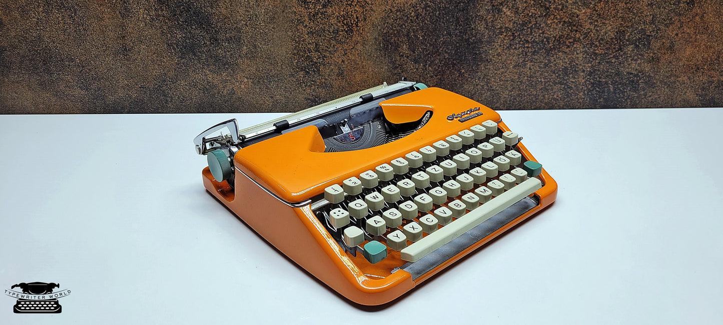 retro writing with the Olympia Splendid 33/66 typewriter orange - a fully refurbished vintage writing machine with a matching carrying case.