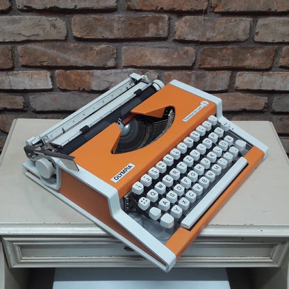 Olympia Traveller Deluxe Typewriter - Fully Functional, Vibrant Orange, and Includes a Stylish White Bag