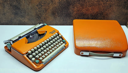 retro writing with the Olympia Splendid 33/66 typewriter orange - a fully refurbished vintage writing machine with a matching carrying case.