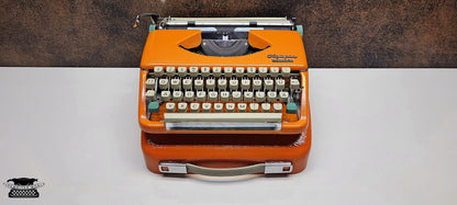 retro writing with the Olympia Splendid 33/66 typewriter orange - a fully refurbished vintage writing machine with a matching carrying case.