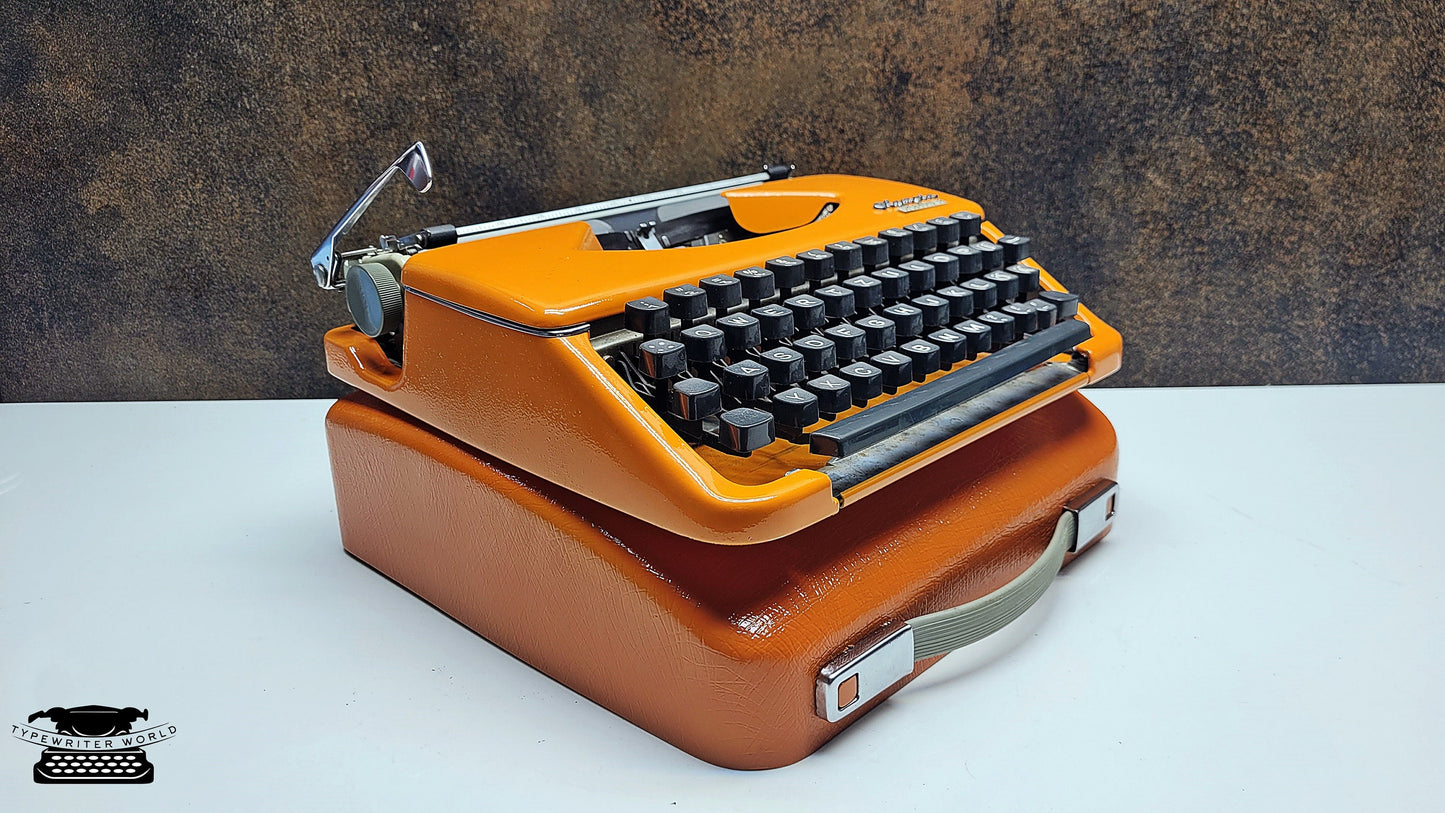 Vintage Olympia Splendid 33/66 Orange Typewriter with Black Keyboard - An Elegant Writing Tool for Love Letters and Personalized Notes